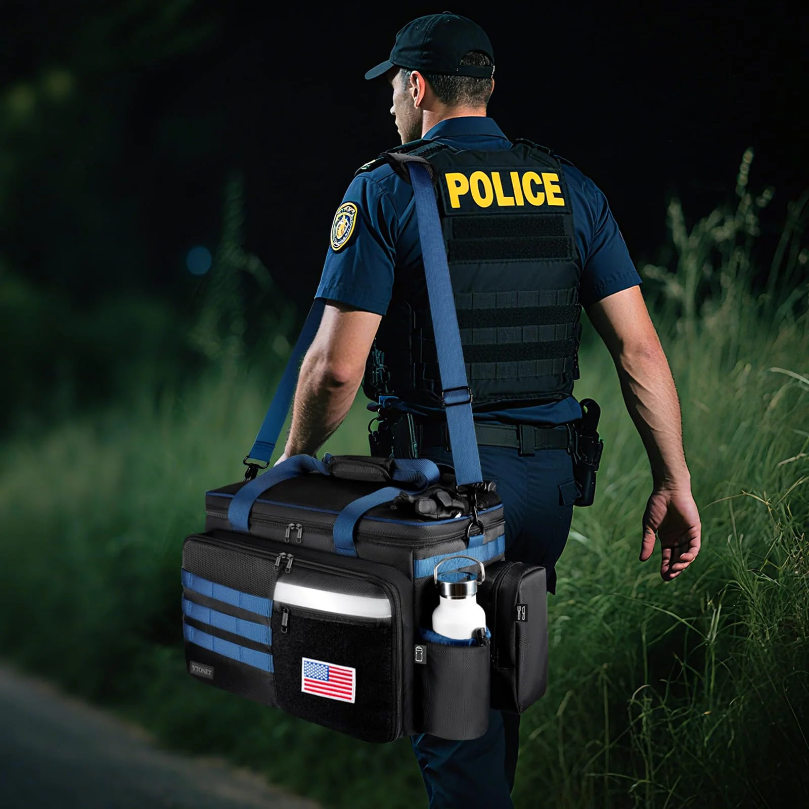 The patrol bag carried by a police officer, seen from behind on a street at night